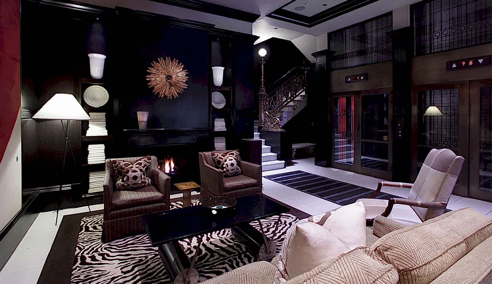 Hotel lobby featuring some special commission art pieces, gas fireplace, and seating for up to five guests.